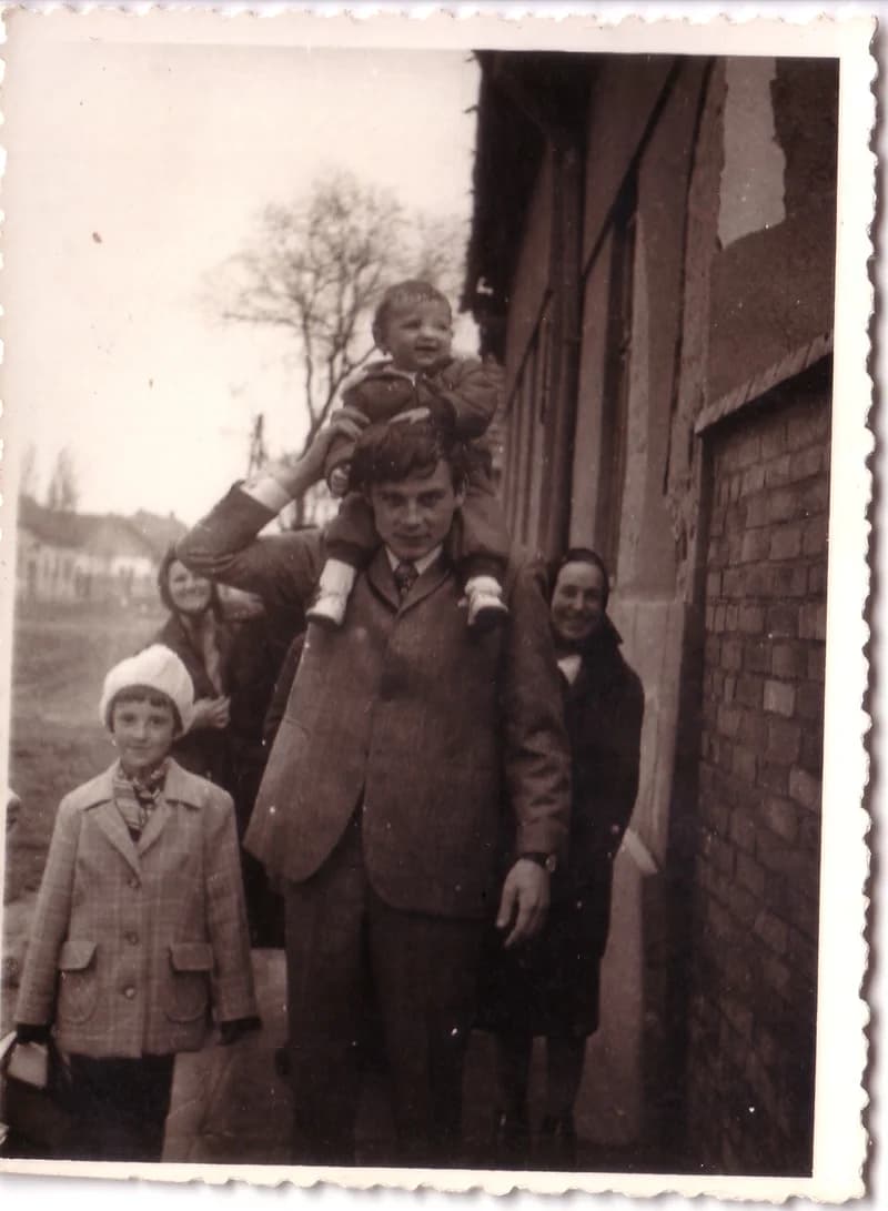 Férfi gyermekkel a nyakában